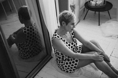Grayscale Photo of a Woman in a Polka Dot Dress 