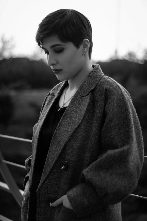 Grayscale Photo of Woman Wearing a Coat