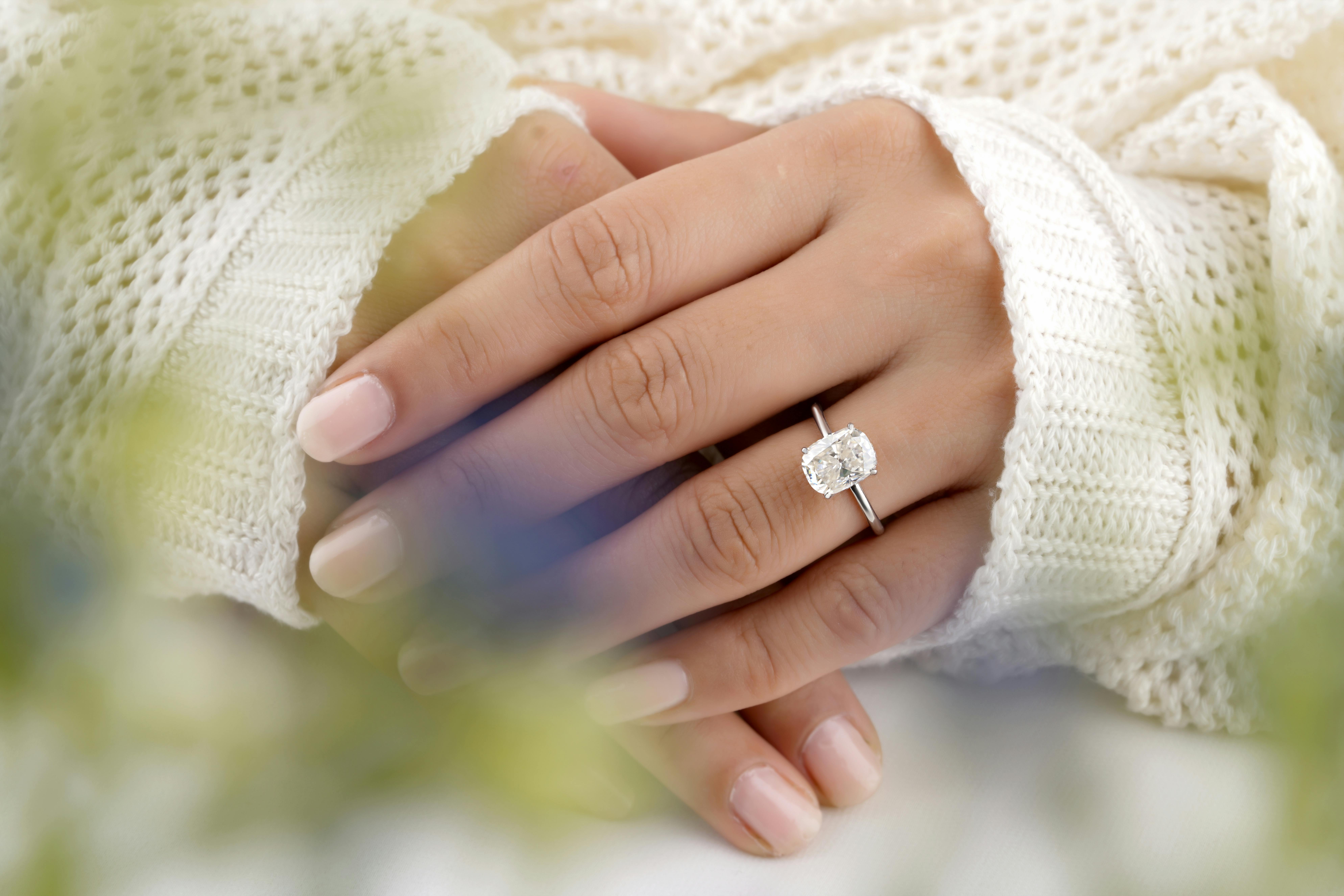 Diamond Ring on White Surface · Free Stock Photo