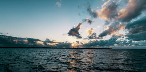 A Body of Water Under the Cloudy Sky