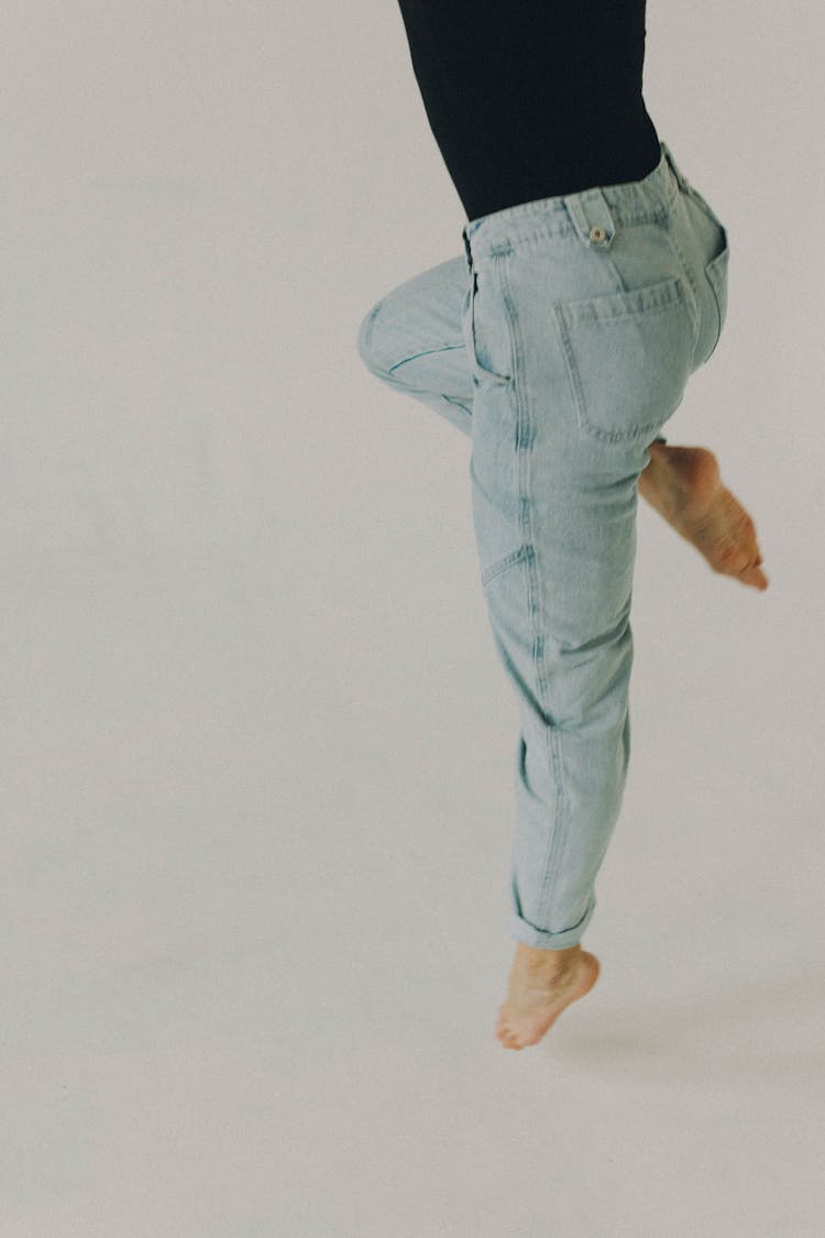 A High Angle Shot Of Female Legs Wearing Jeans In Dance Position 