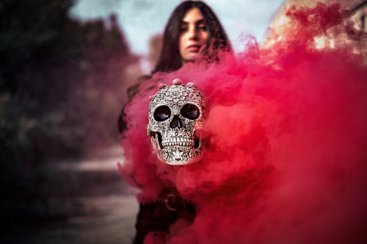 Woman Holding Smoking Skull