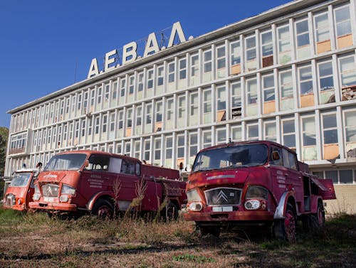 Abandoned Parked Vehicles in front of an Abandoned Building 