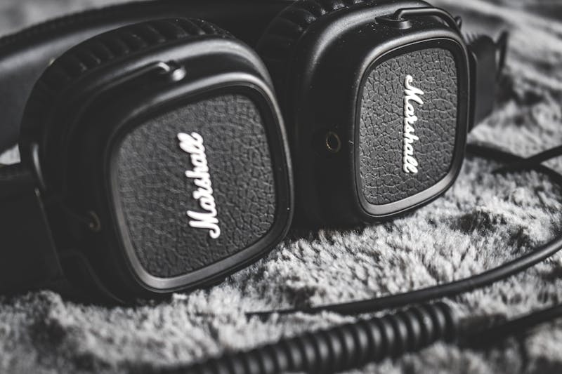 Close-up of vintage Marshall headphones resting on a soft textured surface.