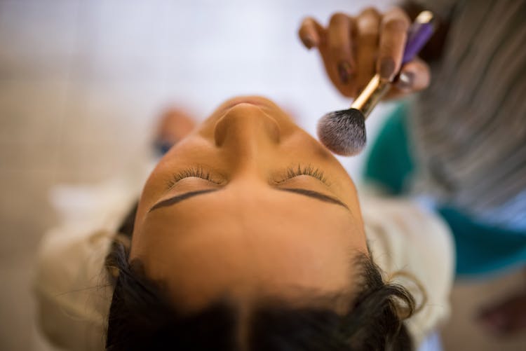 A Person Applying Makeup On A Cadaver