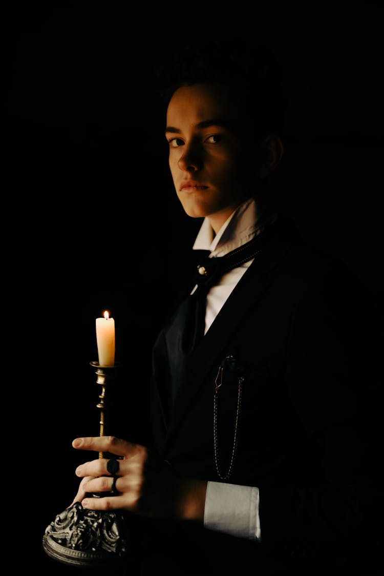 Man With Candle In Darkness