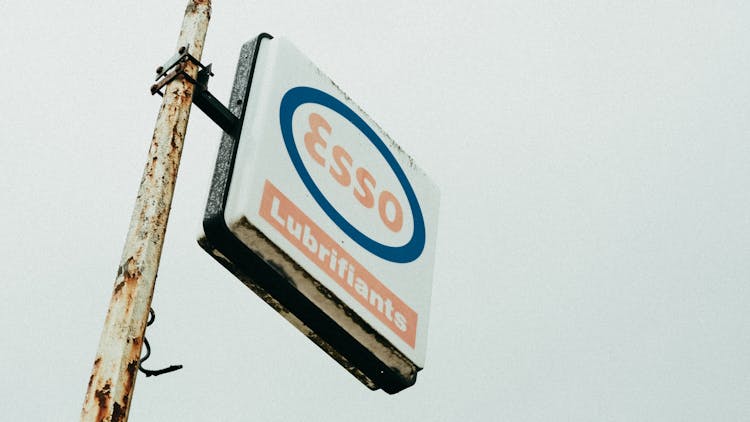 An Esso Lubrifiants Signboard Under White Sky