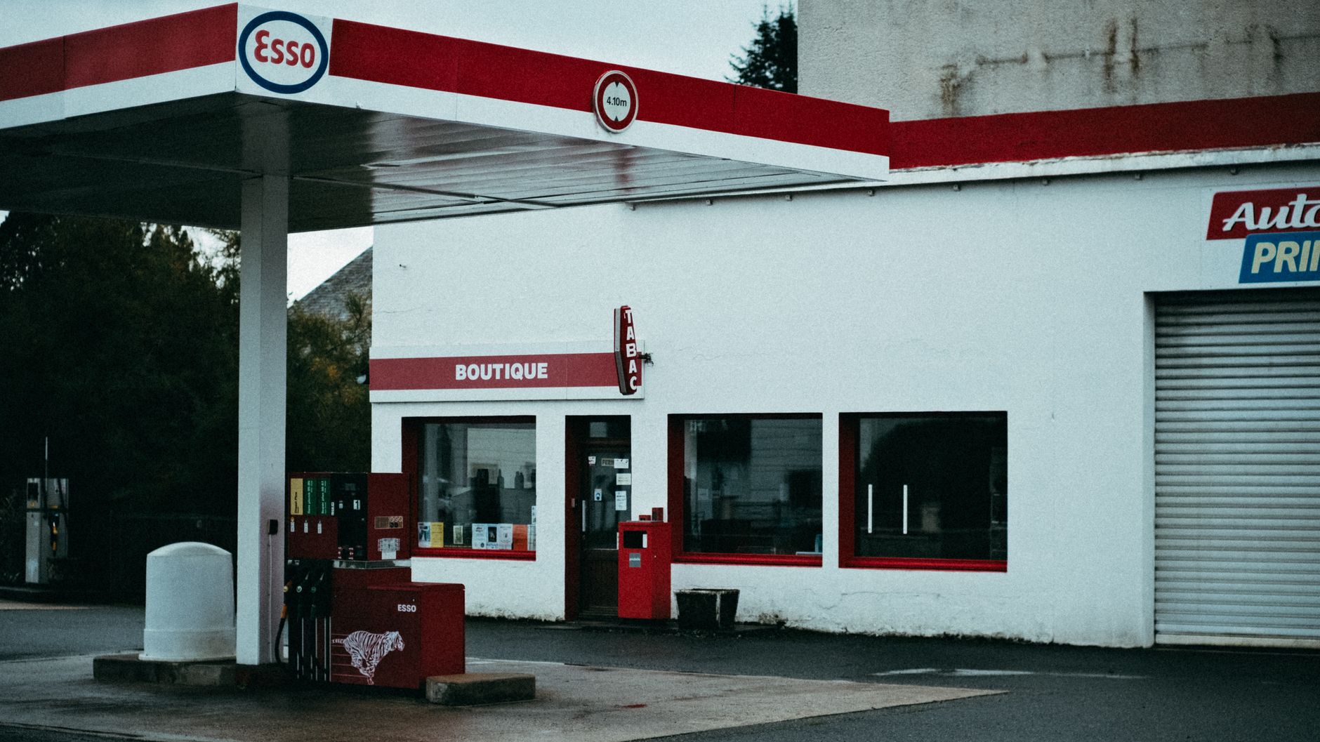 Craft coffee cup on a roadside gas station counter with pastries