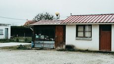 Brown Wooden House Near Bare Trees