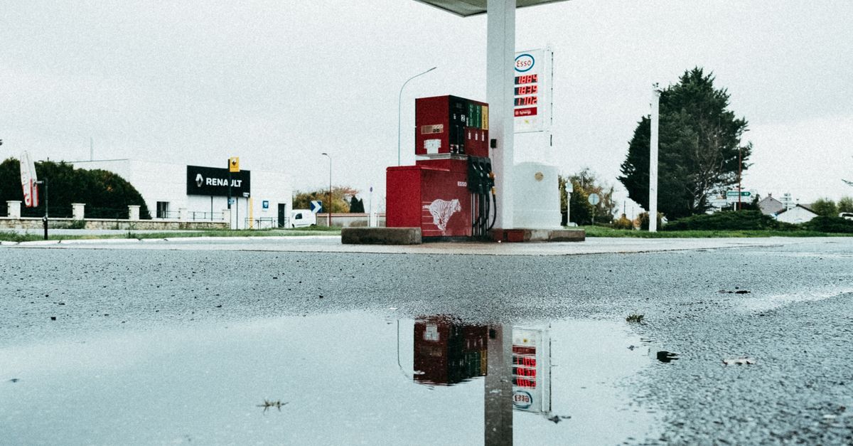 Puddle in a Gasoline Station Pavement · Free Stock Photo