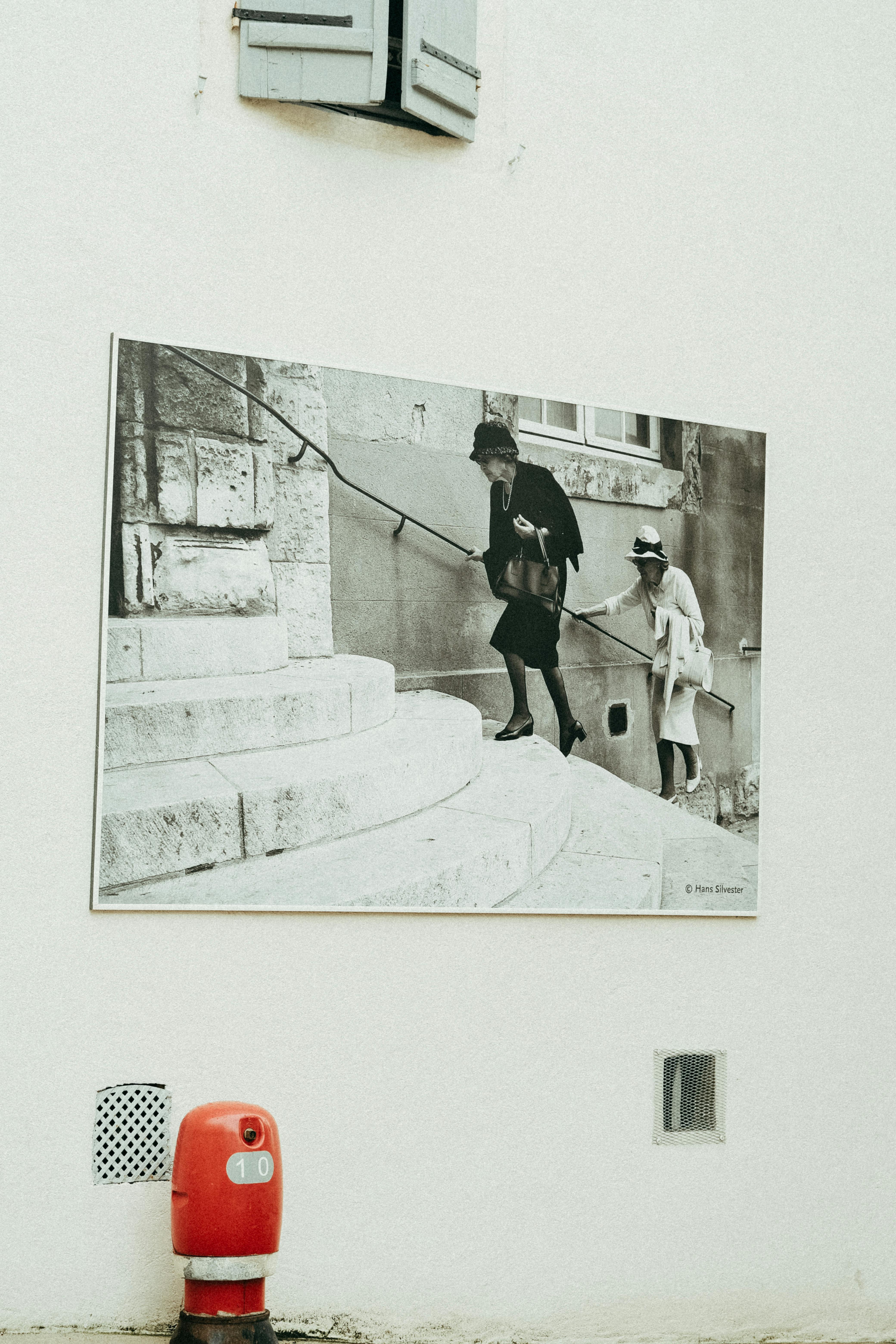 Black and white street art of historical scene on an urban wall. Artistic and vintage feel.