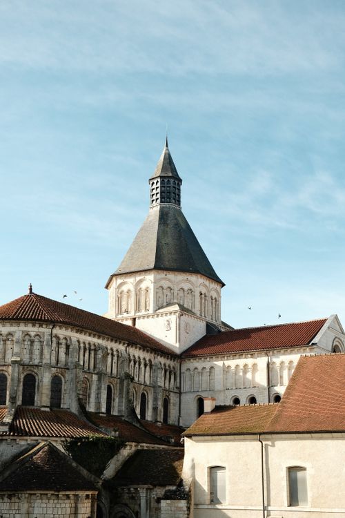 Free A stunning view of a Romanesque-style church under a clear blue sky. Stock Photo