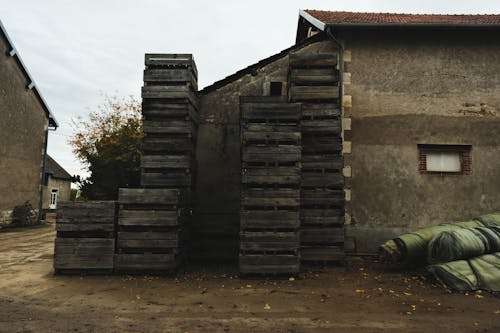 Free Wooden Crates Beside a House Stock Photo