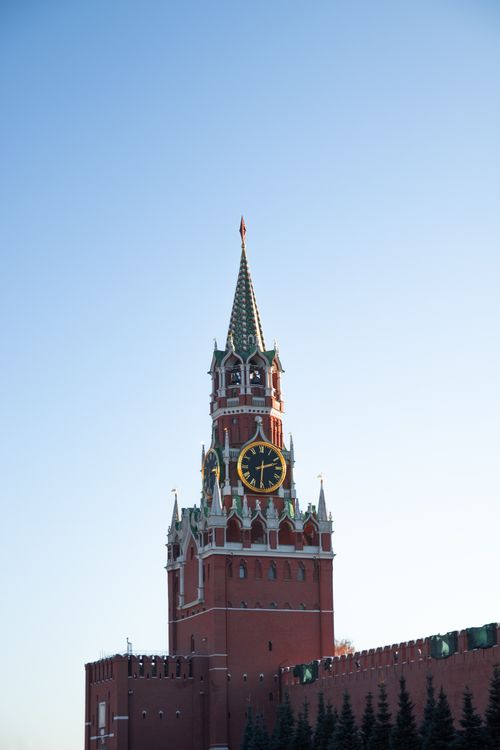 Free The iconic Spasskaya Tower of Moscow Kremlin against a clear blue sky, showcasing classic Russian architecture. Stock Photo