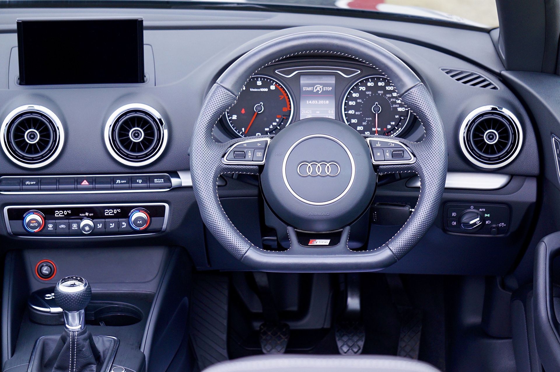 Explore the sleek design of a luxury car interior focusing on the dashboard, steering wheel, and control panel.