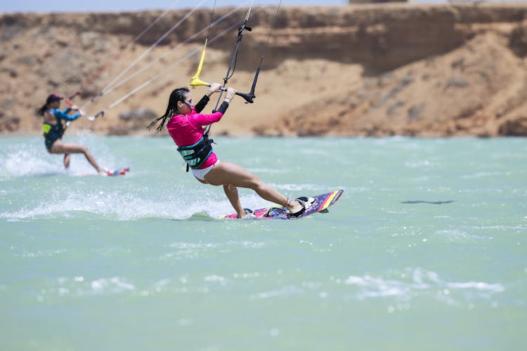 A Woman Kitesurfing On The Ocean