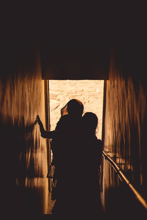 Silhouette of People Climbing Stairs