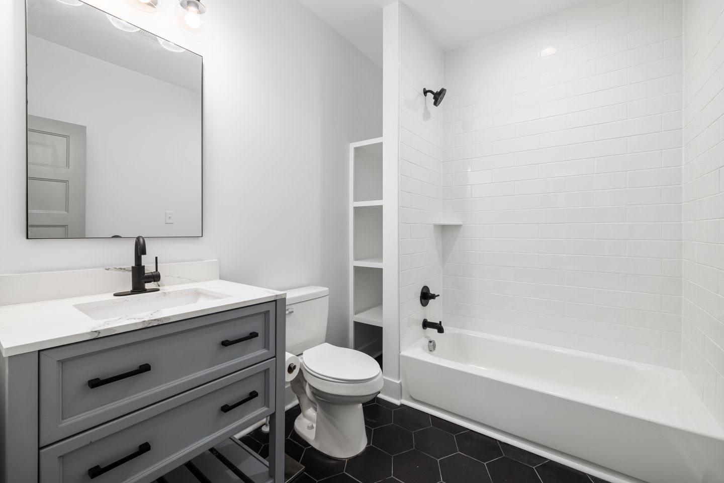 Modern white bathtub, sink, and toilet with elegant fixtures in a sleek bathroom renovation in Guelph. Modern white bathtub, sink, and toilet with elegant fixtures in a sleek bathroom renovation in Guelph.