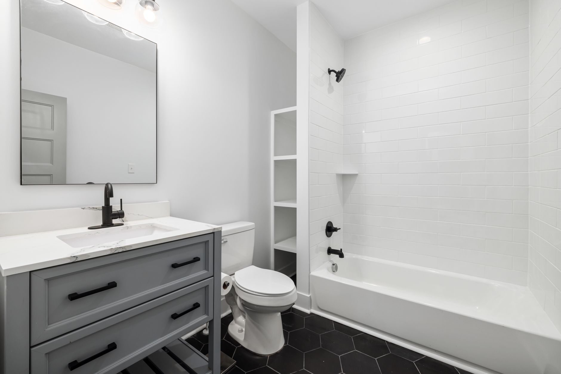Modern white bathtub, sink, and toilet with elegant fixtures in a sleek bathroom renovation in Guelph. Modern white bathtub, sink, and toilet with elegant fixtures in a sleek bathroom renovation in Guelph.
