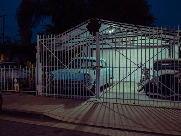 White Grill Fence With Gate Of The Garage