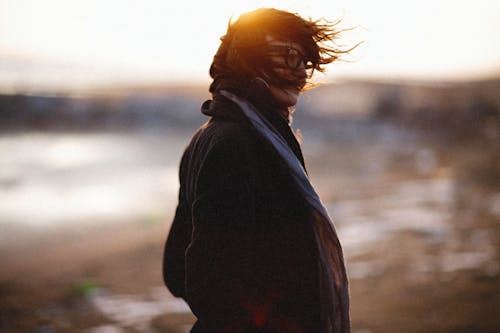 Woman Wearing Black Coat Standing Near a Lake