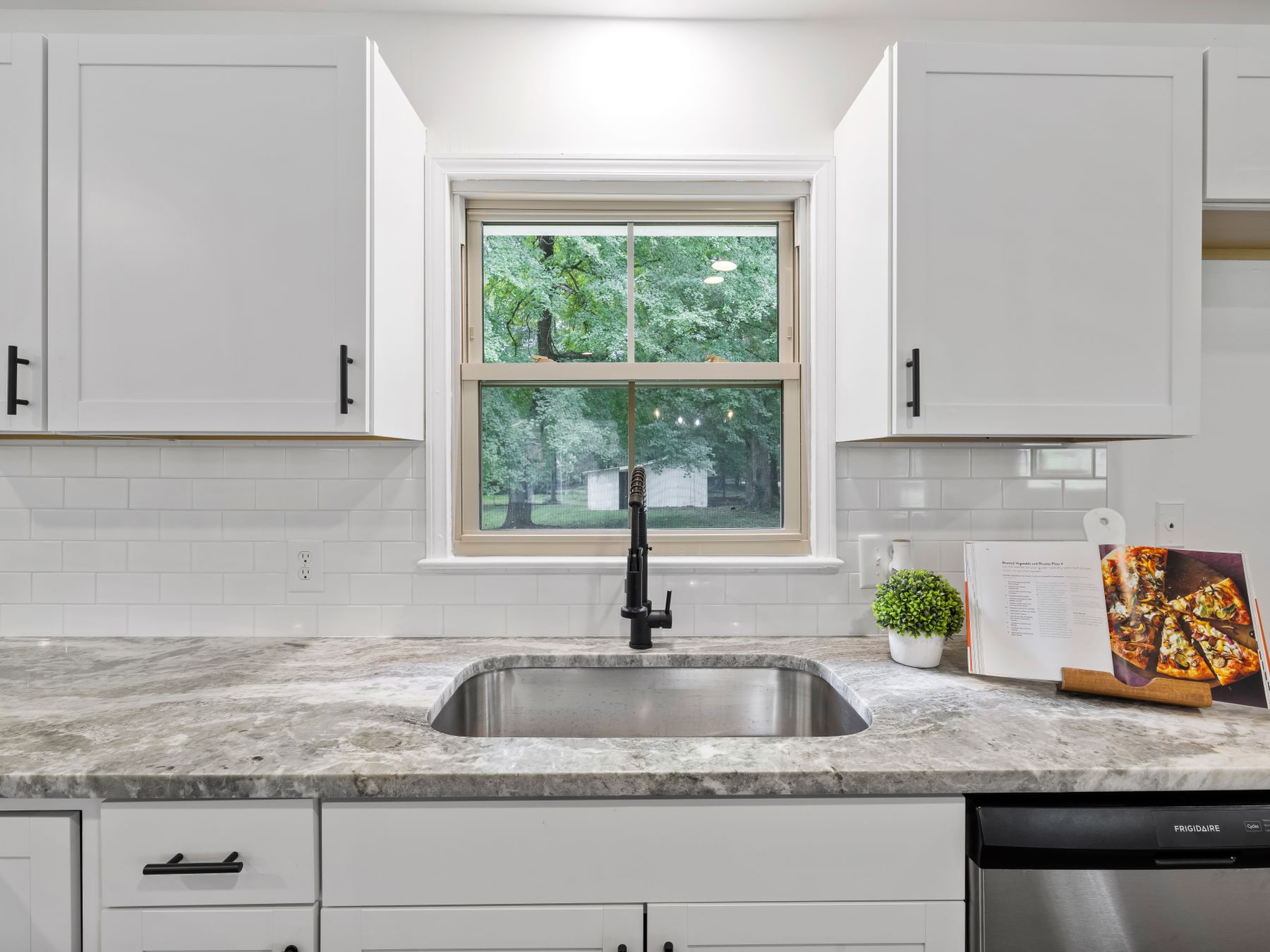 Kitchen Spraying in Hampstead Garden Suburb — a decorator at work mid-project