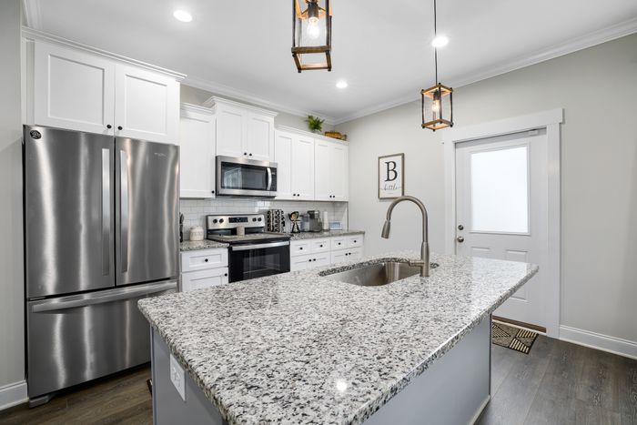 Remodeled kitchen with stainless appliances and granite counters