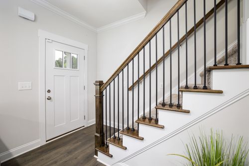 Free Bright and clean modern stairway with wooden accents and white trim in a minimalist home. Stock Photo