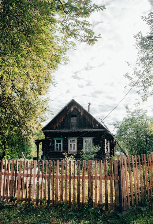 Wooden Fence Surrounding a Wooden House