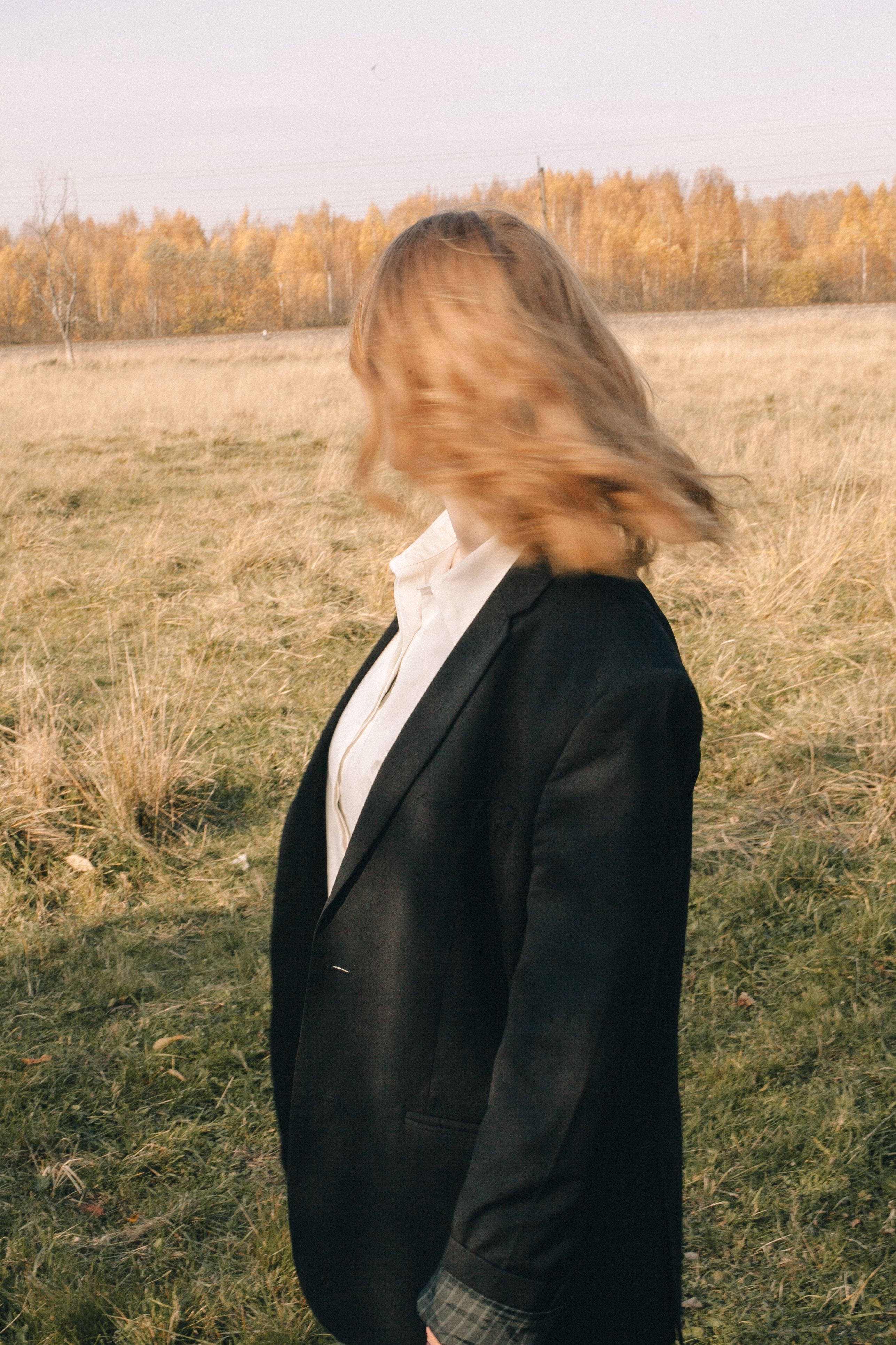 Woman Wearing a Black Blazer Standing on Grass Field · Free Stock Photo