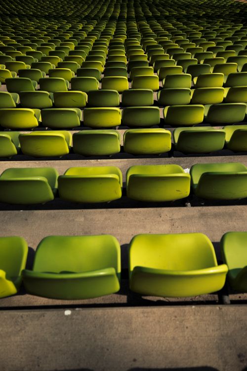 Free Rows of empty green stadium seats creating a geometrical pattern at Munich Olympic Stadium. Stock Photo