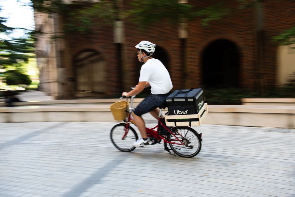 都市で食べ物を配達する自転車に乗った男性、都市交通を紹介しています。