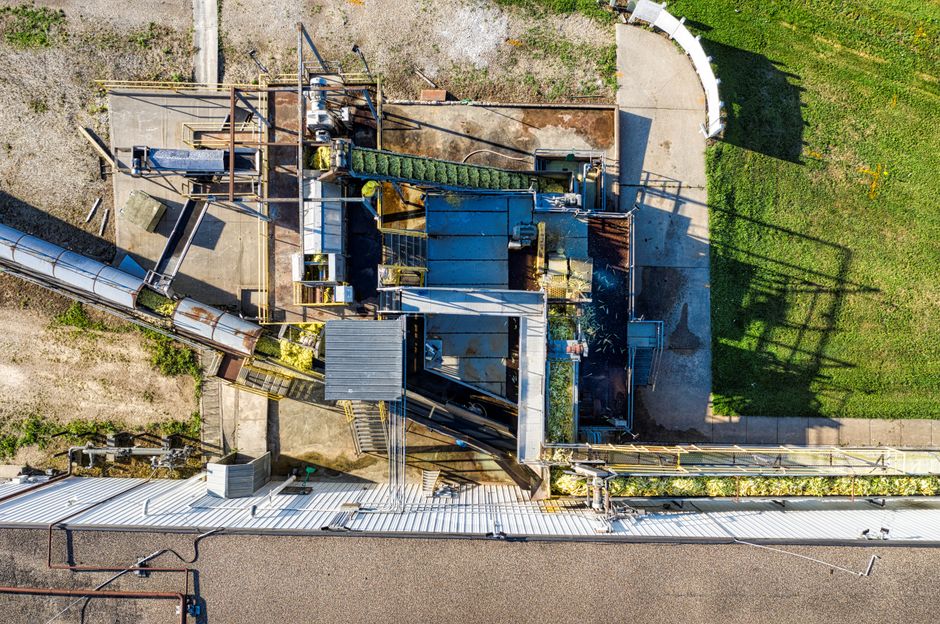 Drone shot of an industrial plant in Plainview, MN showcasing machinery and conveyors.