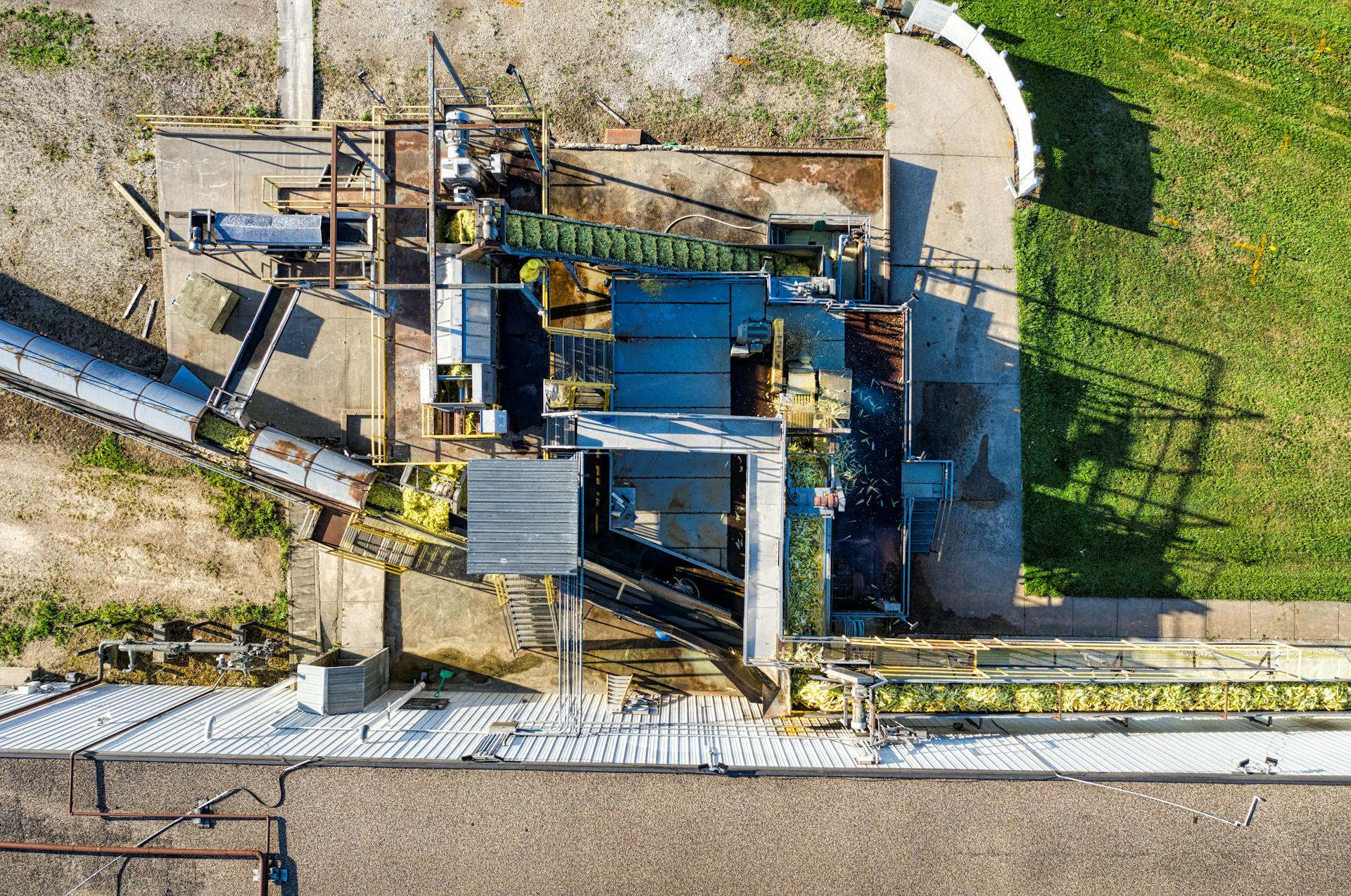 Drone shot of an industrial plant in Plainview, MN showcasing machinery and conveyors.