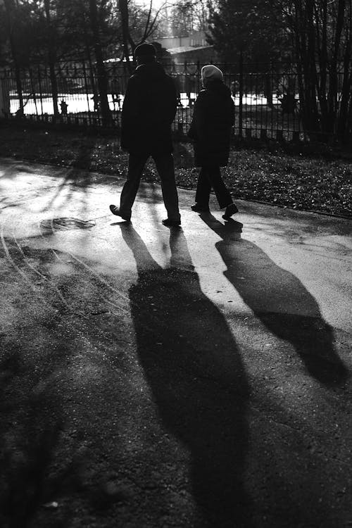 Man and Woman Walking on the Park