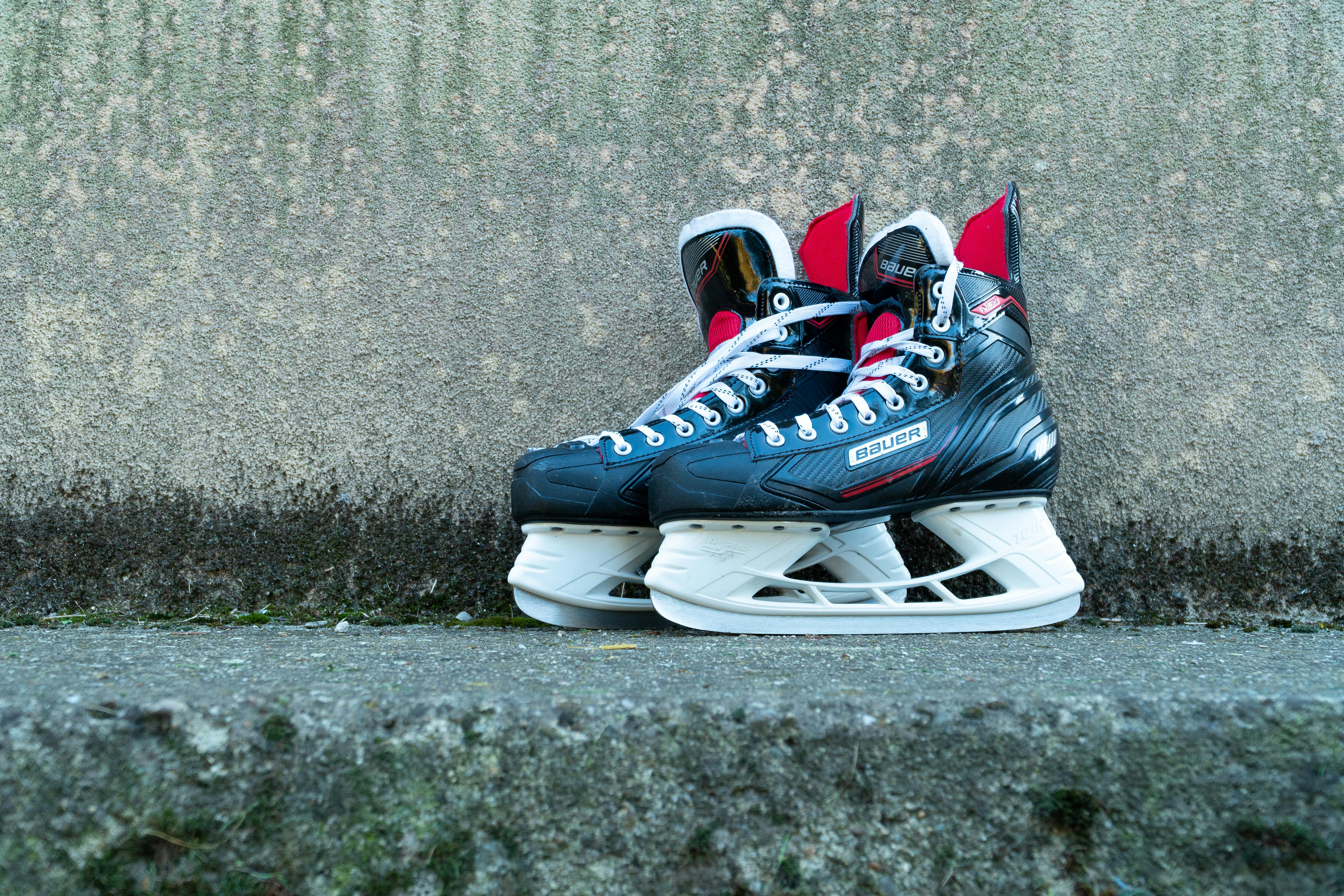 Black and White Ice Skates on Concrete · Free Stock Photo