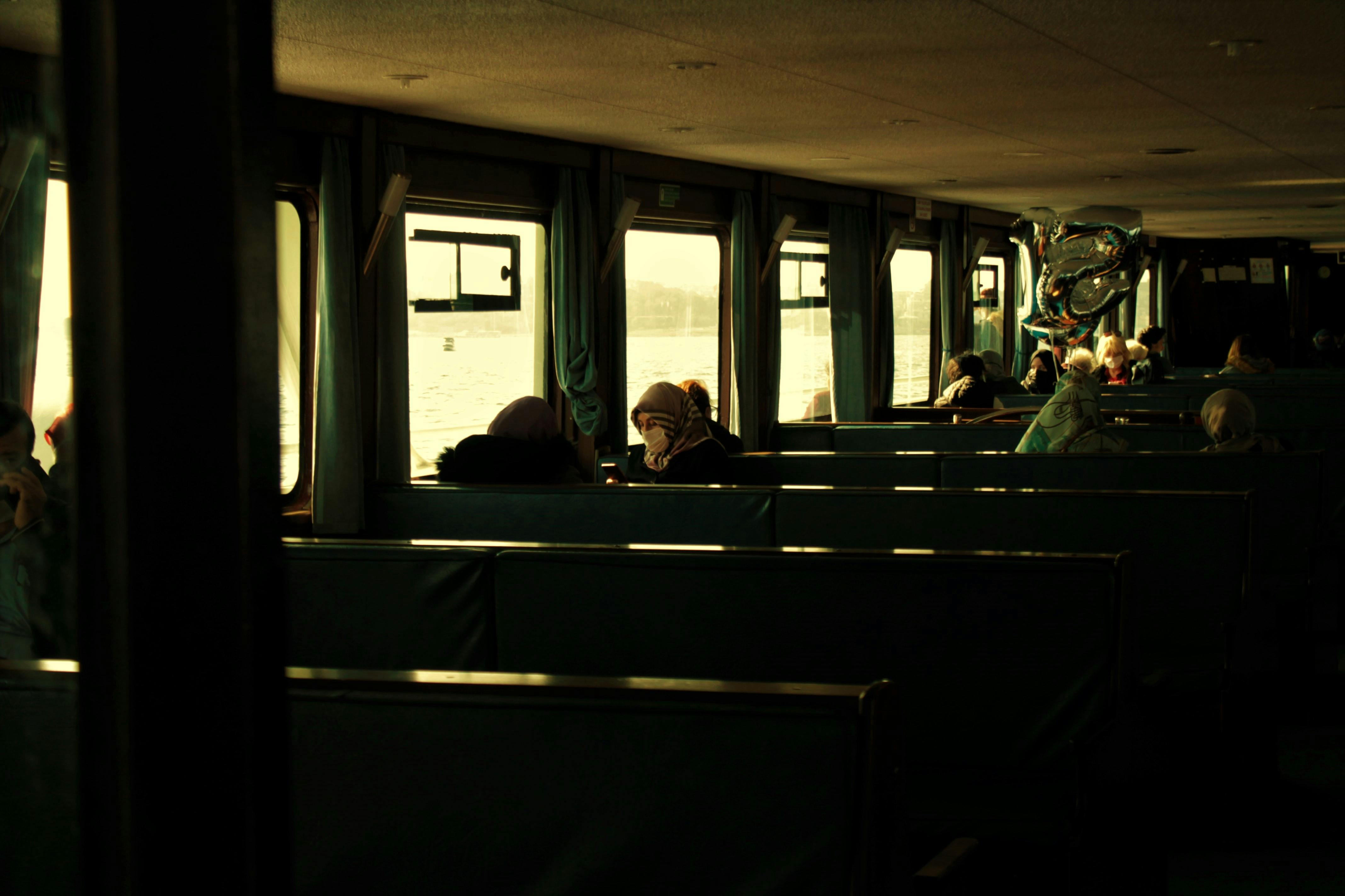 Free A peaceful ferry ride with passengers enjoying the scenic view through the windows. Stock Photo