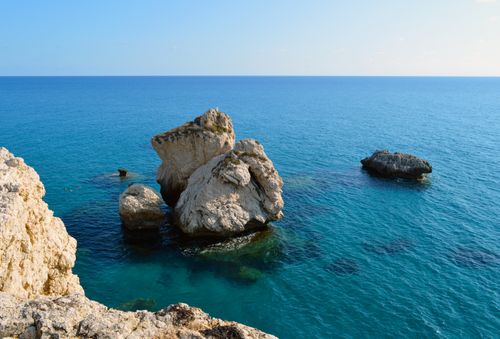 Free Beautiful view of Aphrodite's Rock in Cyprus, showcasing the serene blue ocean and rugged formations. Stock Photo