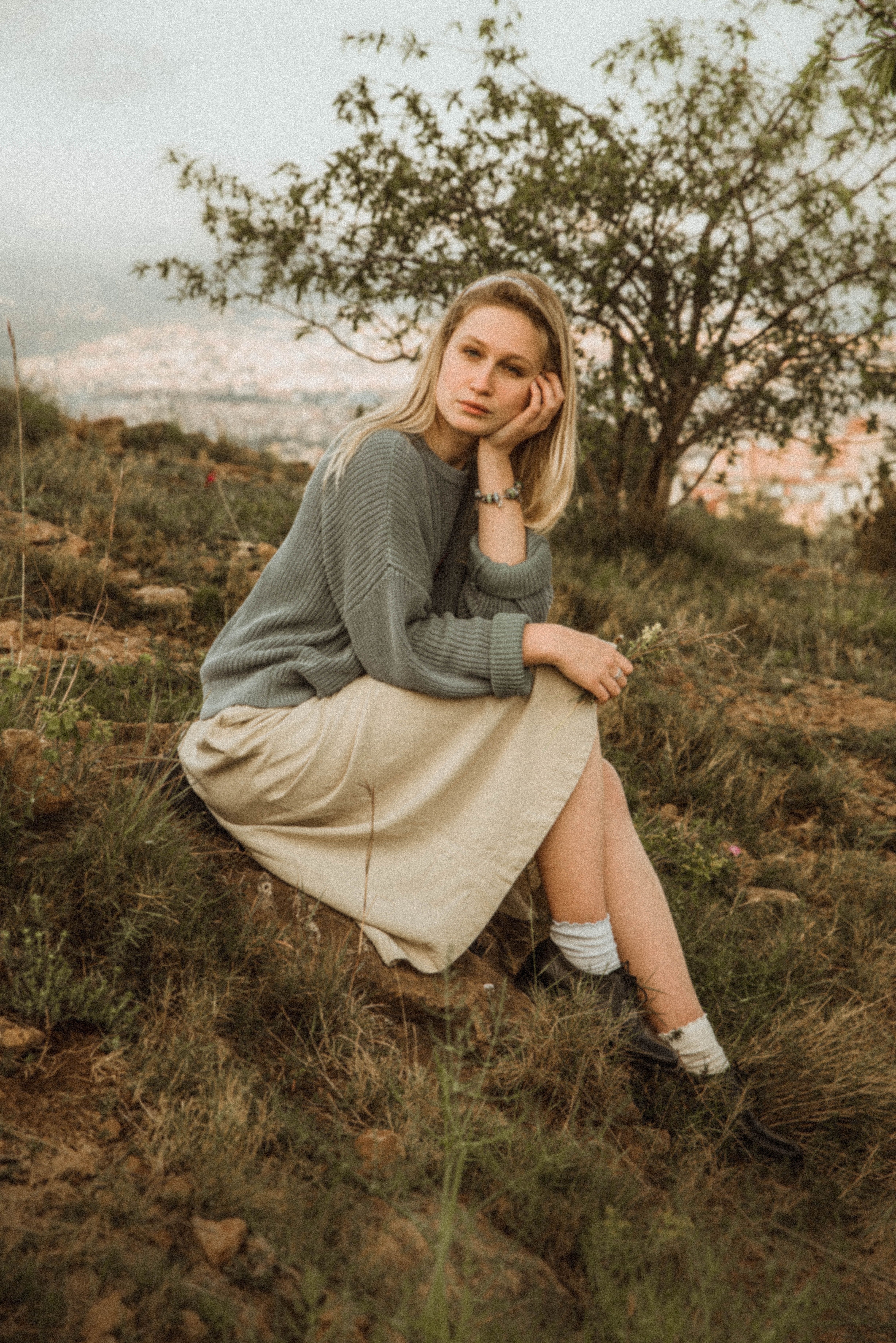 Woman Wearing Sweater and Skirt Sitting on the Grass · Free Stock Photo