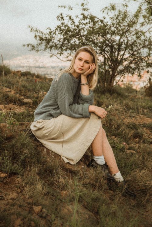 Woman Wearing Sweater and Skirt Sitting on the Grass · Free Stock Photo