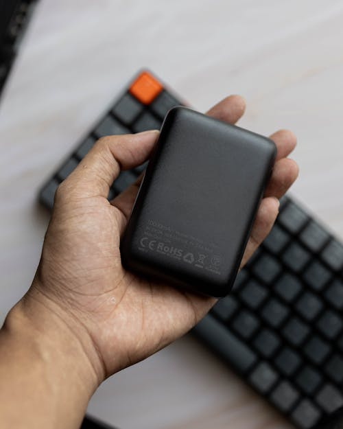 Holding a Power Bank above a Keyboard