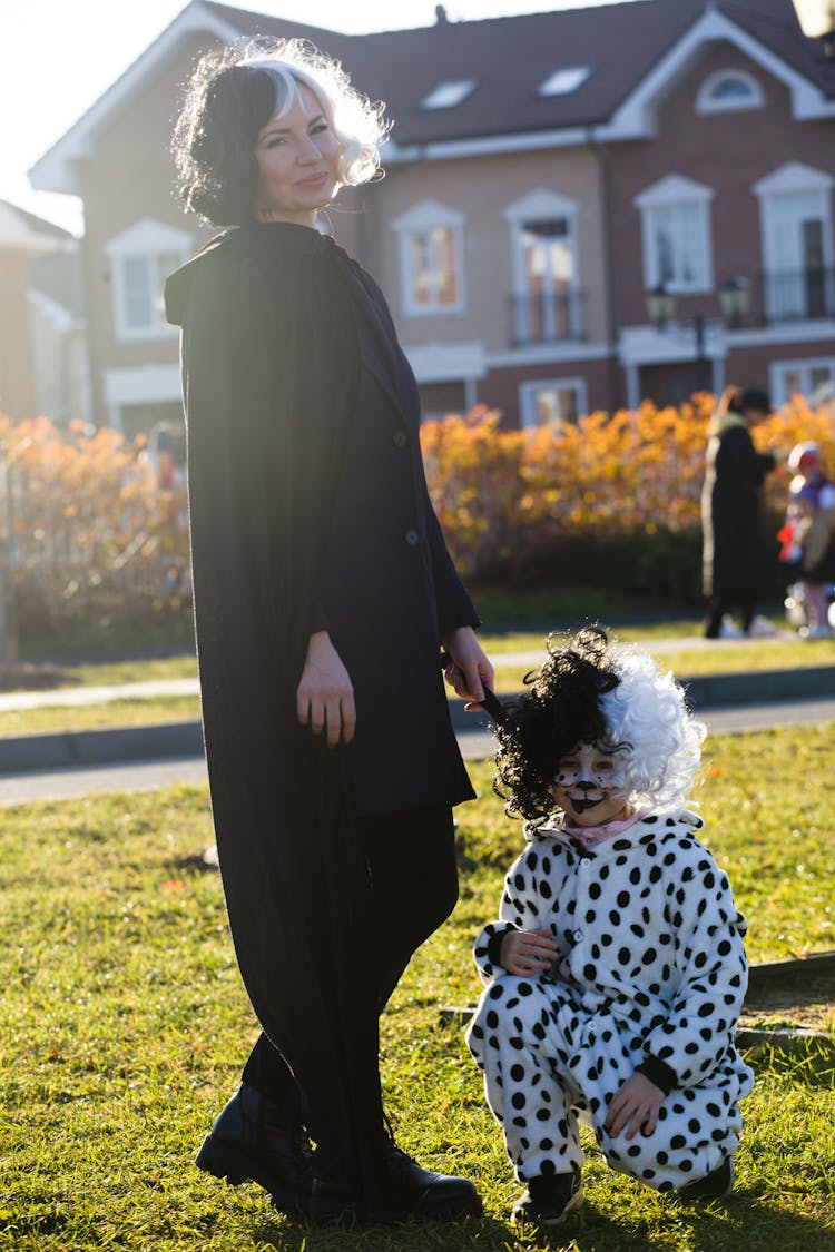 A Woman And A Child In Cruella De Vil And Dalmatian Costumes