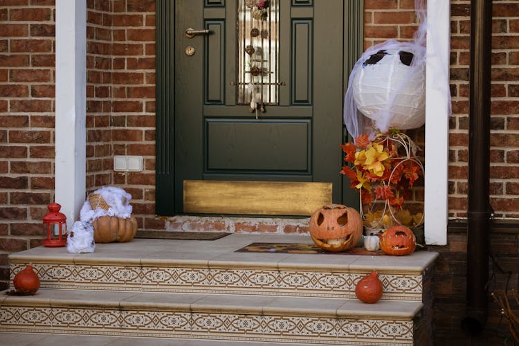 Carved Out Pumpkins Laid On Doorstep