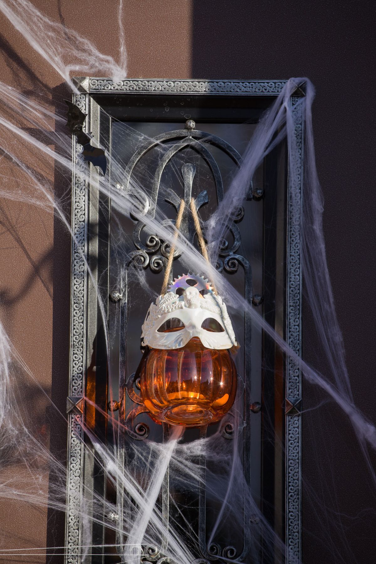 Halloween pumpkin lantern with cobwebs on a mantel display