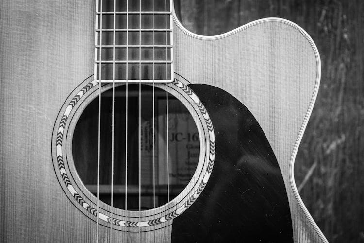 Grayscale Photo Of Cutaway Acoustic Guitar