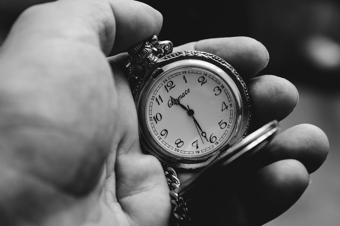 A Person Holding a Pocket Watch · Free Stock Photo