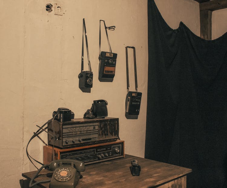 An Old Radio And Cameras In A Room