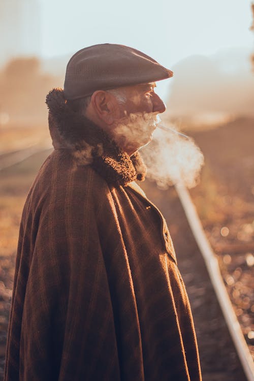 An Elderly Man Smoking a Cigarette