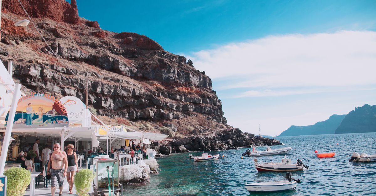 Amoudi Bay Santorini colourful fishing boats white cliffs