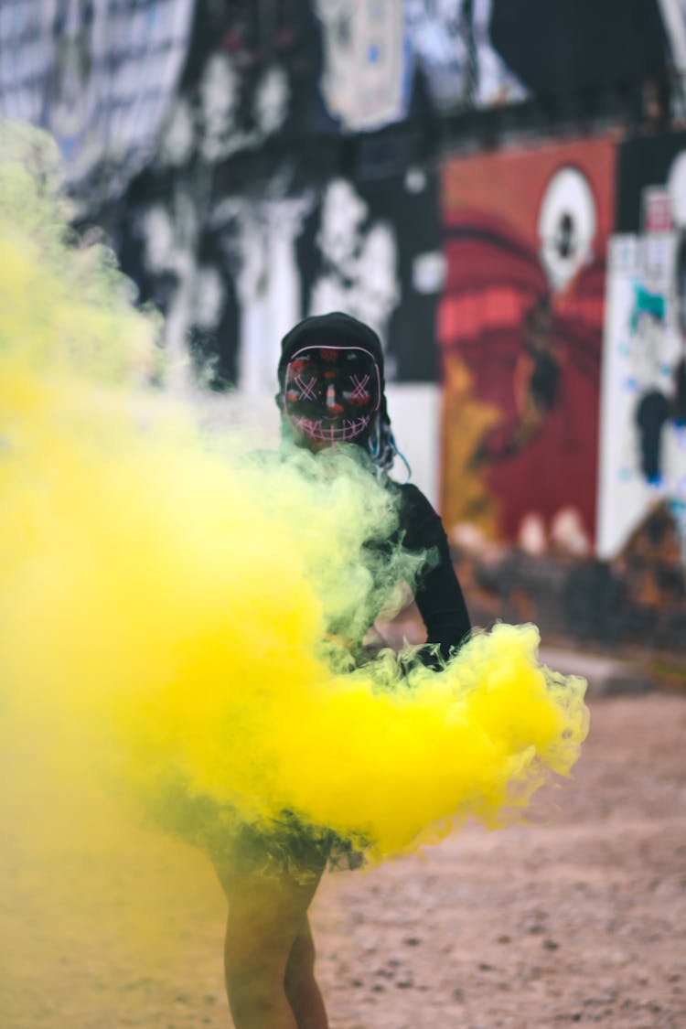 Person Wearing Mask With Yellow Smoke